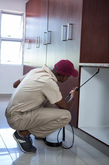 pest-control-man-spraying-pesticide_107420-29671